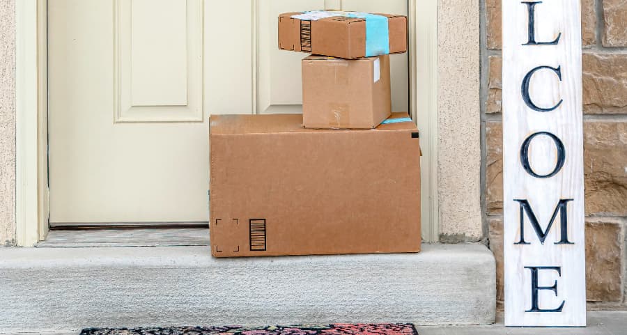 Boxes by the door of a residence with a welcome sign in Camden